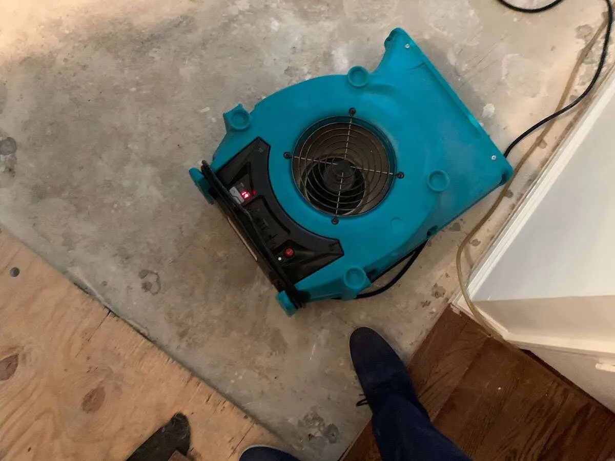 Air mover drying subfloor during Commercial Water Damage Restoration in Hopkinton